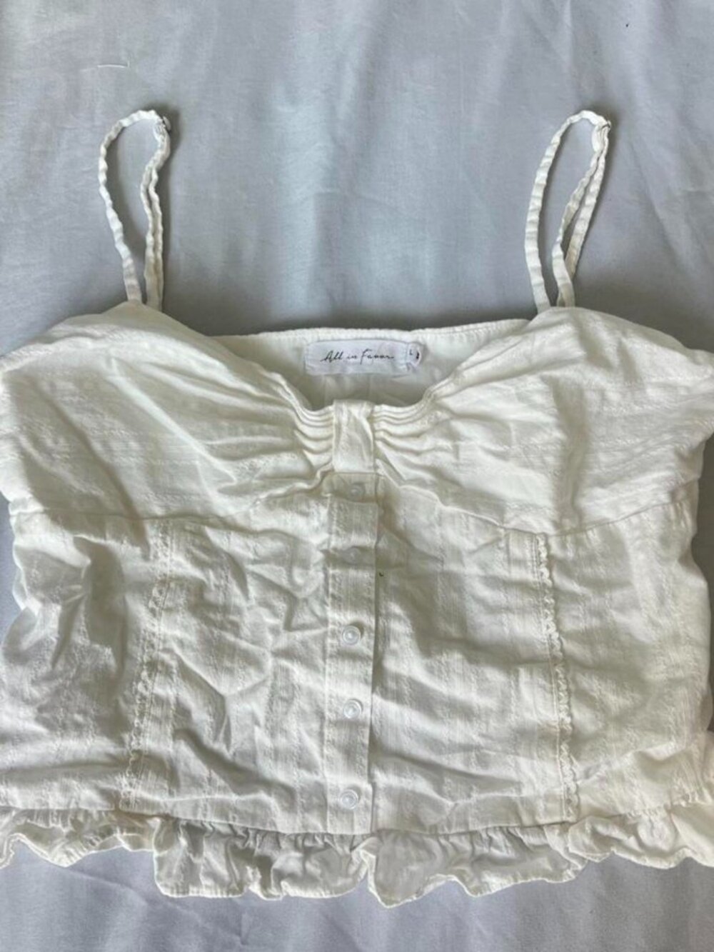 All in Favor white linen crop top with ruffles and buttons